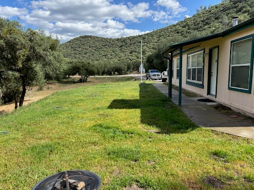 Hunting base camp lawn walkway and evening fire pit area