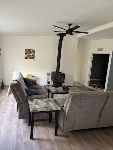 Hunting camp living room featuring cozy wood stove