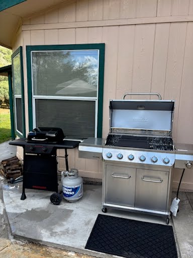 Outdoor BBQ smoker grill station at hunting base camp