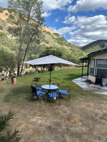 Ranch backyard patio seating with scenic foothill views